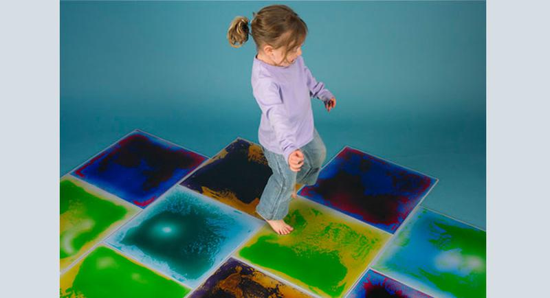 Girl on large interactive floor tiles