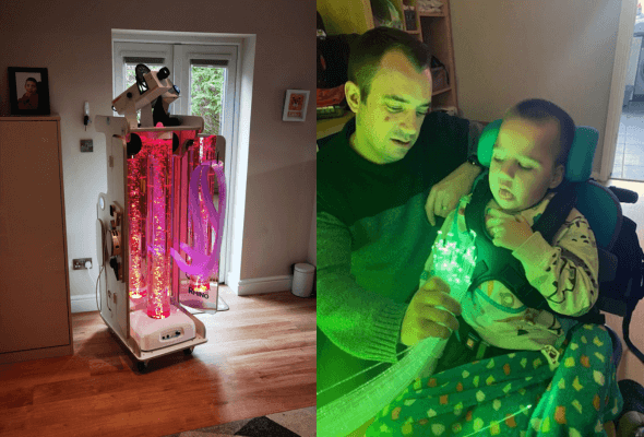 Disabled child engaged with sensory cart
